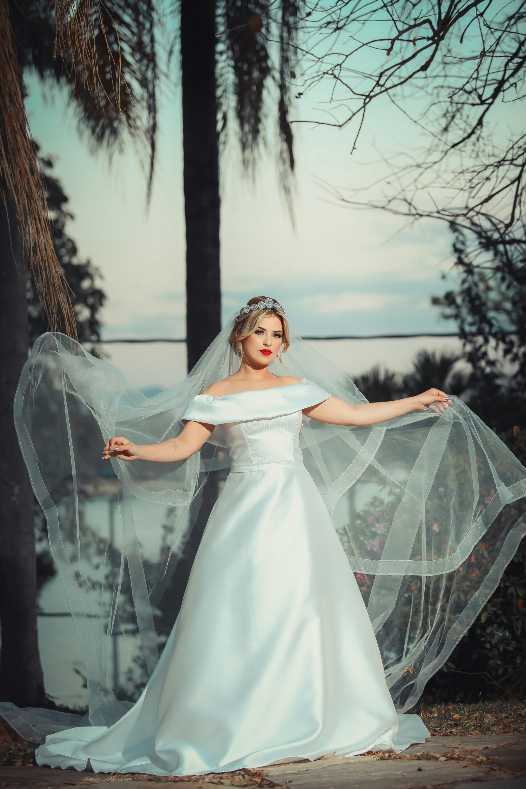 bride adjusting long wedding veil