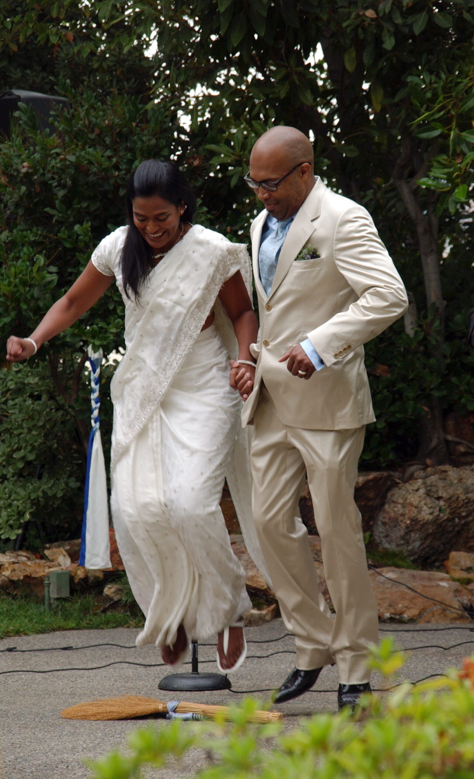 couple jumping broom wedding ceremony